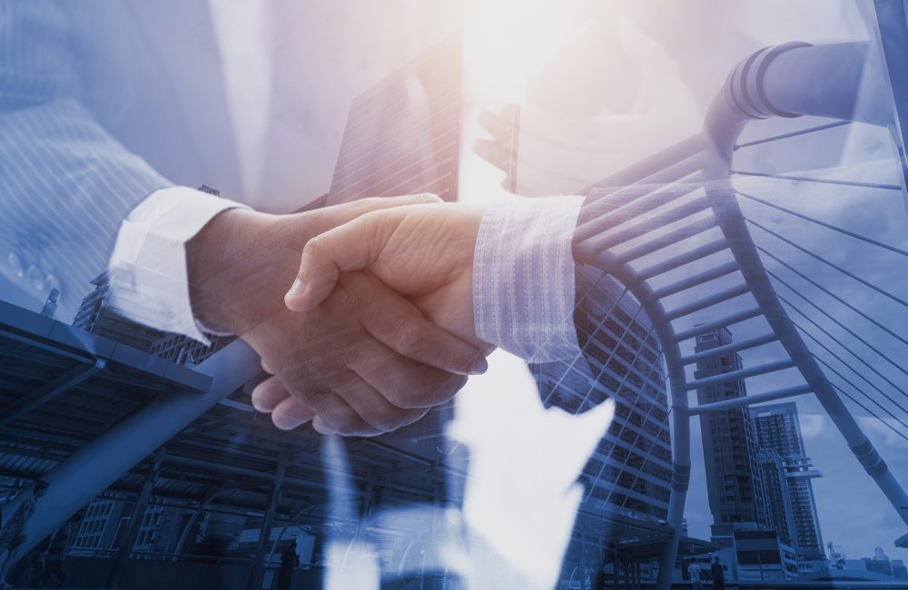Business people shaking hands with city on background. double exposure of teamwork successful Meeting Workplace strategy Concept.