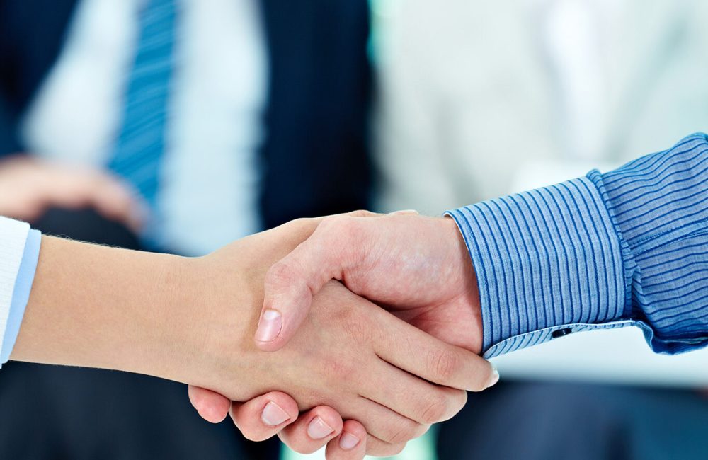 Photo of handshake of business partners after striking deal